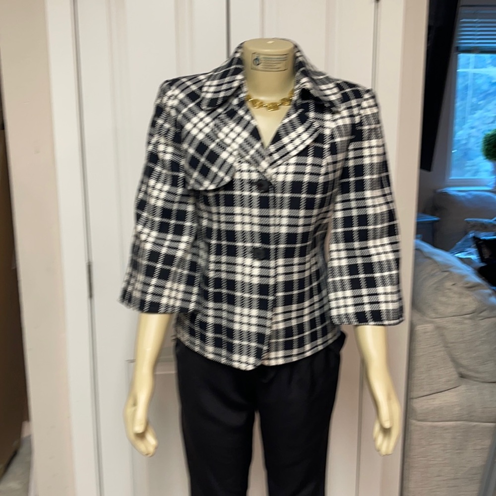 Black and white plaid jacket with flared sleeves. Missing belt.